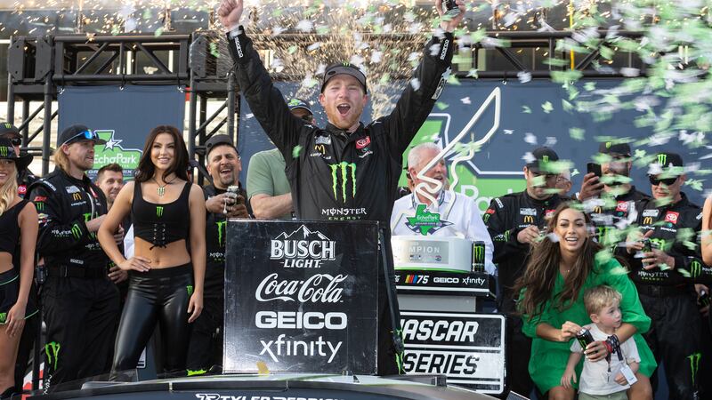 Tyler Reddick, center, celebrates after winning a NASCAR Cup Series auto race at Circuit of...