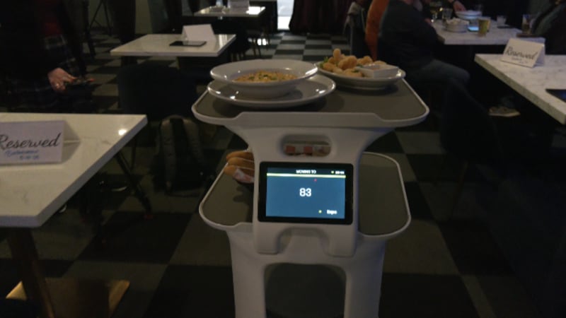 Rosie, the Server Robot, delivering food to a table.