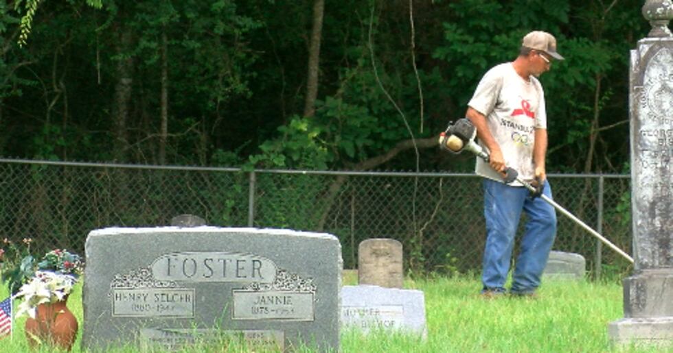 Volunteers cleanup Freeman Cemetery during a family work day in Hudson.