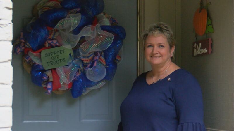 Kim Cooper McDonald stands in front of her Nacogdoches home that exhibits patriotism.