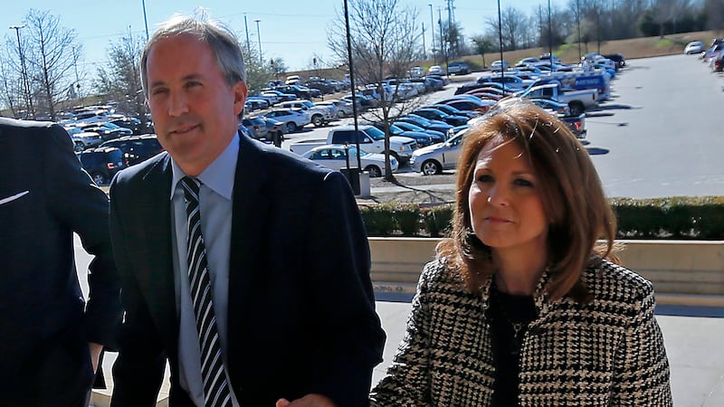 FILE - Texas Attorney General Ken Paxton, left, arrives at the Collin County Courthouse with...