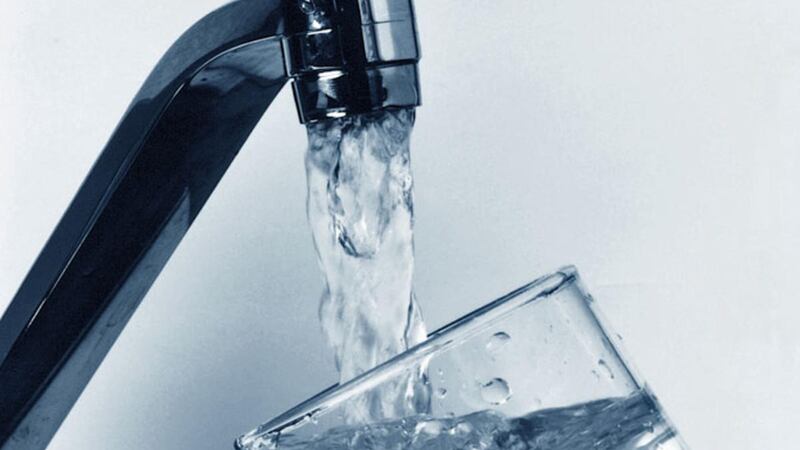 Water coming out of a faucet into a glass.