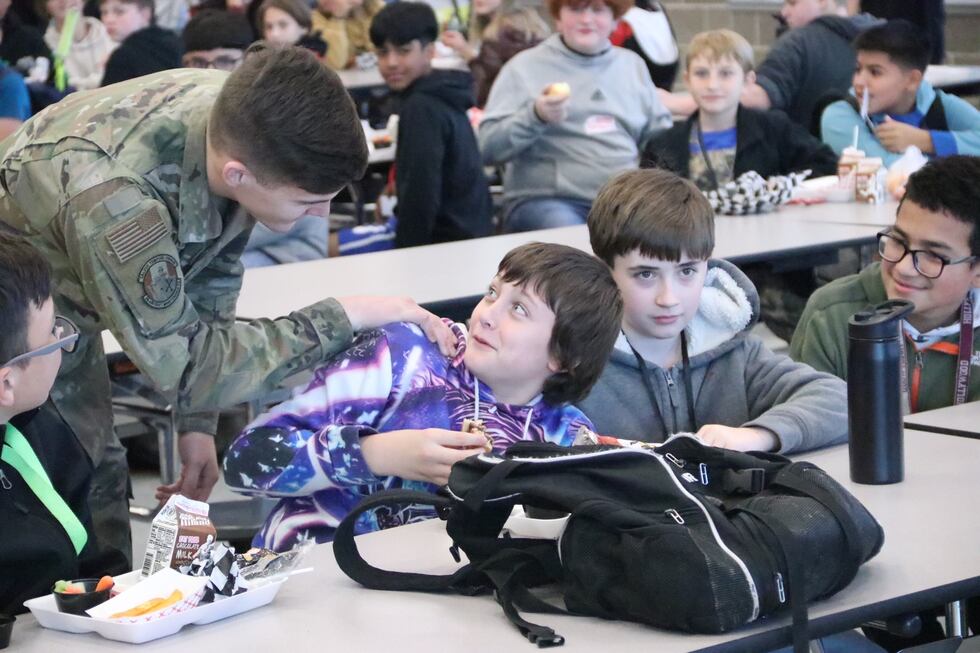 Blaine Sparks surprises his brother Xander during lunch at Kilgore Middle School on Friday
