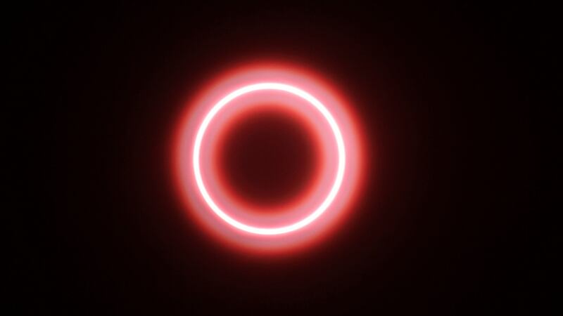 FILE - In this Thursday, Dec. 26, 2019 photo, an annular solar eclipse is seen through a...